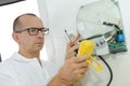 Electrician examining current voltage with screwdriver tester Royalty Free Stock Photo