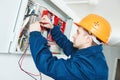 Electrician examining current voltage with screwdriver tester Royalty Free Stock Photo