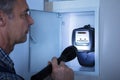 Electrician Examining A Electricity Meter