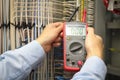 Electrician Examining Fusebox With Voltage Tester. Royalty Free Stock Photo