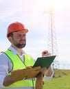 An electrician in the fields near the power transmission line. Royalty Free Stock Photo