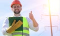 An electrician in the fields near the power transmission line. Royalty Free Stock Photo