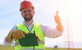 An electrician in the fields near the power transmission line. Royalty Free Stock Photo