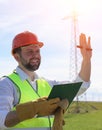 An electrician in the fields near the power transmission line. Royalty Free Stock Photo