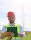 An electrician in the fields near the power transmission line. T Royalty Free Stock Photo