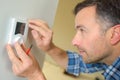 Electrician fitting thermostat system Royalty Free Stock Photo