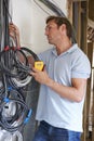 Electrician Fitting Wiring On Construction Site Royalty Free Stock Photo