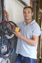 Electrician Fitting Wiring On Construction Site Royalty Free Stock Photo