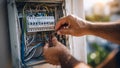 Electrician fixing electrical panel wiring Royalty Free Stock Photo