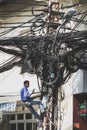 Electrician fixing messy cables - communication network