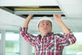 Electrician fixing neon on ceiling Royalty Free Stock Photo