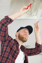 electrician fixing neon on ceiling Royalty Free Stock Photo