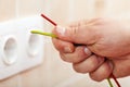 Electrician hand with colorful wires