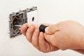 Electrician hand mounting a wall fixture Royalty Free Stock Photo