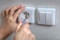 Electrician hands installing electrical wall sockets, and light Royalty Free Stock Photo