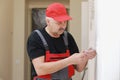 Electrician hands tighten electrical wires in wall fixture or socket using a screw driver - closeup. Installing electrical outlet Royalty Free Stock Photo