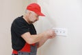 Electrician hands tighten electrical wires in wall fixture or socket using a screw driver - closeup. Installing electrical outlet Royalty Free Stock Photo