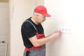 Electrician hands tighten electrical wires in wall fixture or socket using a screw driver - closeup. Installing electrical outlet Royalty Free Stock Photo