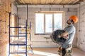 Electrician contractor with electric cable at a construction site Royalty Free Stock Photo