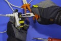 Electrician adjusts a screw on an electrical outlet