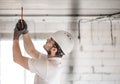 Electrician installer with a tool in his hands, working with cable on the construction site Royalty Free Stock Photo