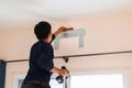 Electrician installing air conditioner unit, Repairman fixing air conditioning, Technician man installing an air conditioner unit Royalty Free Stock Photo