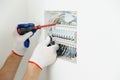 Electrician installing an electrical fuse box .