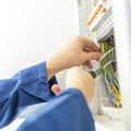 Electrician installing an electrical fuse box Royalty Free Stock Photo