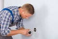 Electrician installing electrical socket