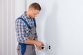 Electrician installing electrical socket Royalty Free Stock Photo