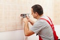 Electrician installing electrical wall fixture Royalty Free Stock Photo