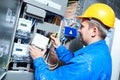 Electrician installing energy saving meter Royalty Free Stock Photo
