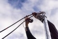Electrician installing ground wire on metal pole with cloudy sky Royalty Free Stock Photo