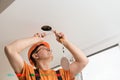 The electrician is installing an LED spotlight Royalty Free Stock Photo