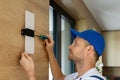 electrician installing led wall lamp at home. interior lighting Royalty Free Stock Photo