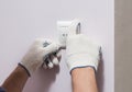 Electrician installing light switch, close up photo