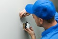 Electrician installing light switch on the wall