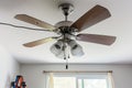 electrician installing new ceiling fan in living room Royalty Free Stock Photo