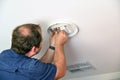 Electrician installing new  ceiling light fixture Royalty Free Stock Photo