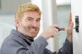 Electrician installing socket in new house Royalty Free Stock Photo