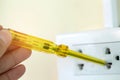 electrician installing a switch with a tester screwdriver at plug socket Royalty Free Stock Photo