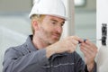 electrician installing wall socket