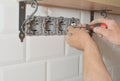 Electrician installing wall socket