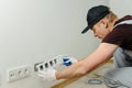 Electrician installs decorative frame. Royalty Free Stock Photo