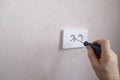 An electrician installs an electrical outlet on the wall. Apartment and house renovation Royalty Free Stock Photo