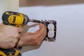 Electrician installs lighting switch in the wall Royalty Free Stock Photo