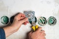 An electrician installs an outlet with pliers during a repair. Hands of the master close-up during work Royalty Free Stock Photo