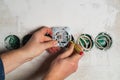 An electrician installs a socket with a screwdriver during a repair. Hands of the master close-up during work Royalty Free Stock Photo