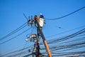Workers repairing work on electric post power pole