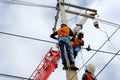 Electrician lineman repairman worker at climbing work on electric post power pole Royalty Free Stock Photo